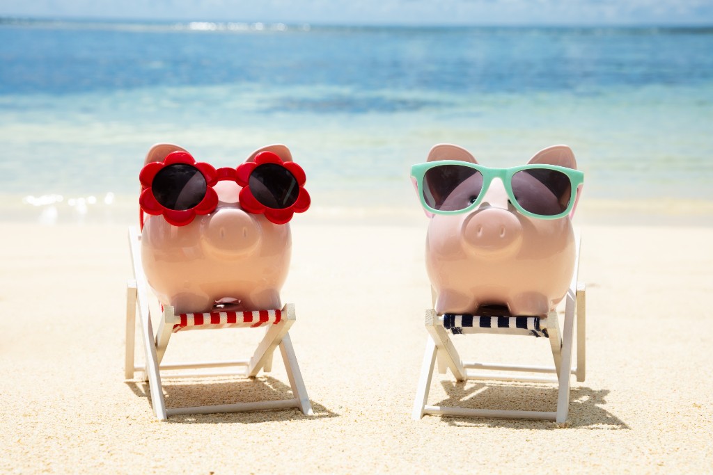 Two Pigs Wearing Black Glasses On The Beach