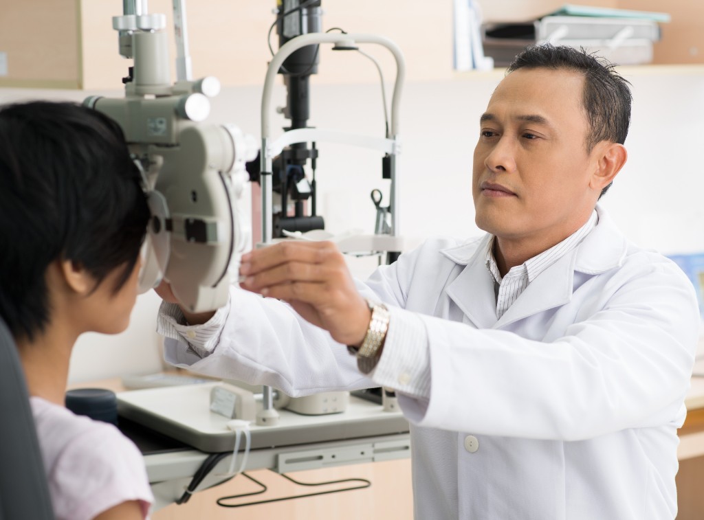 Doctor Inspecting Eye Of A Patient